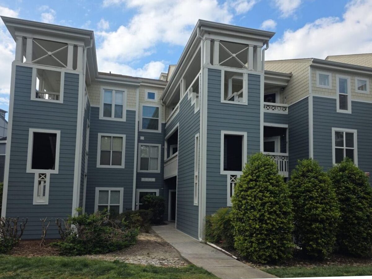 Blue fiber cement siding on multi-story building