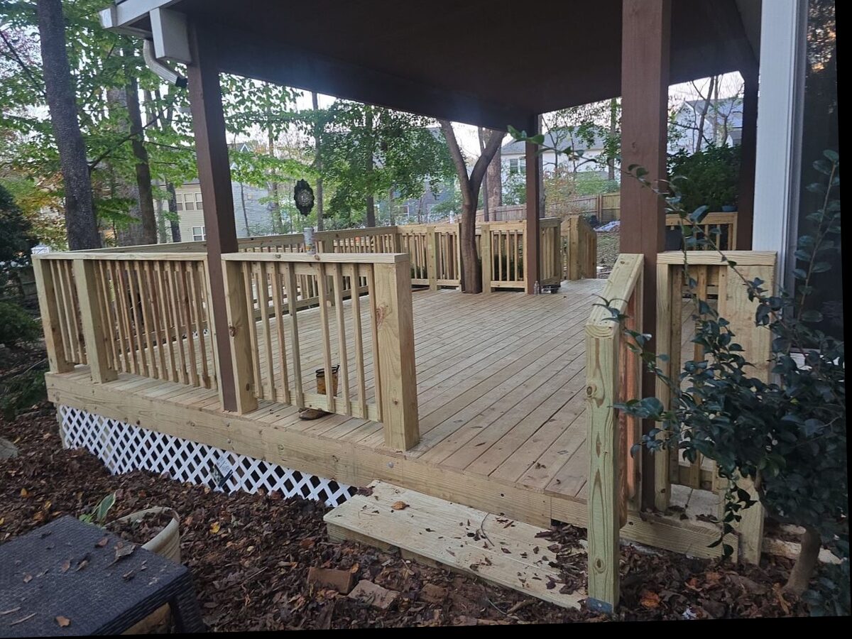 Newly built pressure-treated wood deck with railings